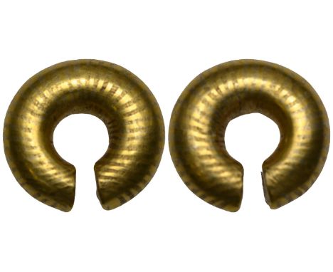 Celtic gold so-called ring-money, in the form of a plain penannular ring with traces of bands in alternate metallic colours, 