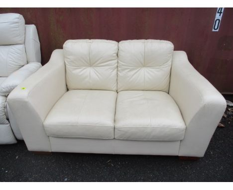 A modern cream leather two seater sofa 