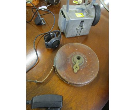 A mixed lot to include a surveyors tape measure, a railway lamp and a Garmin golf watch 