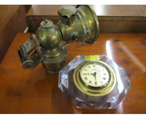 A Lucas King of the Road car/motorcycle acetylene lamp and a Scoler table top clock mounted within a glass paperweight style 