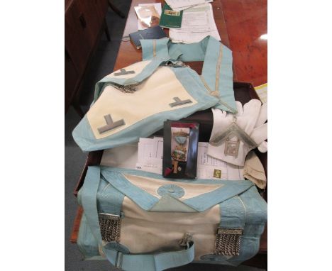 A small leather suitcase containing Masonic regalia including an enamelled and silver gilt medal, an apron, a sash with silve