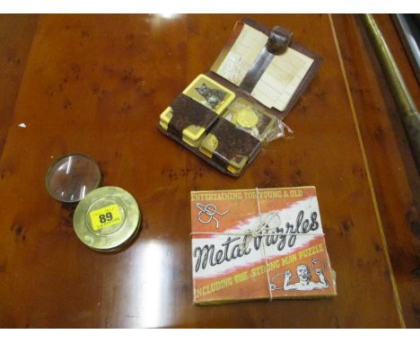 A mixed lot to include a playing card case set, a brass cased magnifying glass and a puzzle 