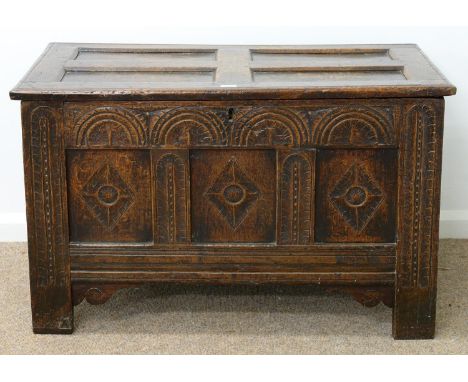 A CHARLES II JOINED OAK CHEST, LATE 17TH C, THE THREE PANEL FRONT CARVED AT LATER DATE WITH LUNETTES AND LOZENGES, ON STILES,