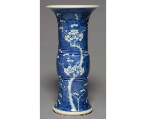 A CHINESE BLUE AND WHITE BEAKER SHAPED VASE, PAINTED WITH PRUNUS ON A CRACKED ICE GROUND, 34CM H, KANGXI MARK Good condition