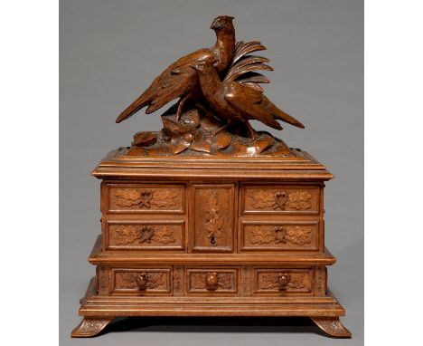 A SWISS BLACK FOREST LIME WOOD JEWEL CASKET, C1900, THE LID SURMOUNTED BY NATURALISTICALLY CARVED PHEASANTS ON ROCKS, THE LID