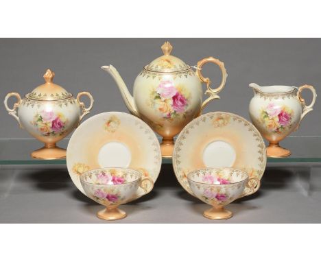 A CONTINENTAL PORCELAIN VASE SHAPED TEA SERVICE, C1900, PRINTED AND PAINTED WITH FULL BLOWN CABBAGE ROSES ON A SHADED APRICOT