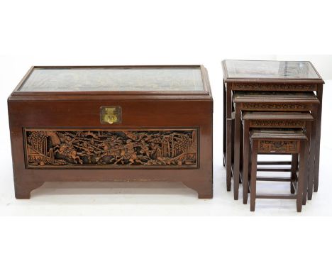A CHINESE CARVED CAMPHOR WOOD TRUNK ON BRACKET FEET, 60CM H; 103 X 53CM AND A NEST OF FOUR TABLES EN SUITE, 56CM H; 51 X 35CM