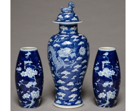 A CHINESE BLUE AND WHITE DRAGONS VASE AND COVER, WITH CRACKED ICE GROUND, 29CM H, KANGXI MARK AND A PAIR OF SIMILAR, SMALLER 