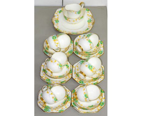 A PARAGON BONE CHINA TEA SERVICE, C1940, WITH GREEN, YELLOW AND BLUE STYLISED FLORAL BORDER, PRINTED MARK Good condition