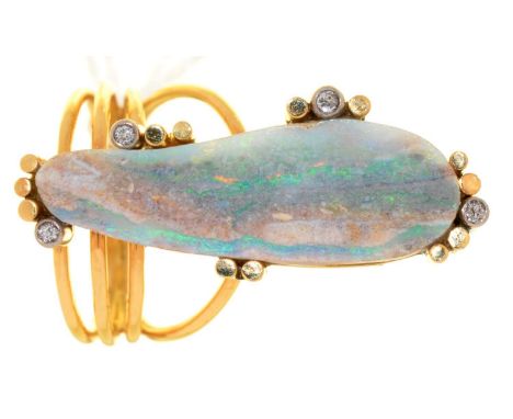 AN OPAL AND DIAMOND RING, THE IRREGULAR OPAL SECTION WITHIN DIAMOND ACCENTS, IN GOLD, WIREWORK HOOP, HEAD 12 X 32MM, UNMARKED