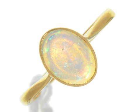 AN OPAL RING, IN GOLD, MARKED 18CT, 2.1G, SIZE N Polish of opal scratched and now rather dull; light wear