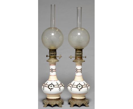 A PAIR OF NORTHERN EUROPEAN MOUNTED GLASS OIL LAMPS, FRENCH OR BELGIAN, LATE 19TH C, OF BOTTLE SHAPED OPAL GLASS DECORATED WI