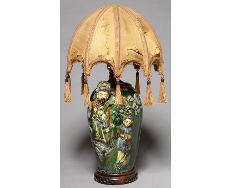 A CHINESE GLAZED BISCUIT HIGH RELIEF MOULDED OVIFORM VASE, EARLY 20TH C DECORATED WITH FIGURES ON A GREEN GLAZE, ADAPTED AS A