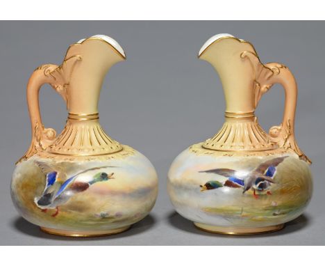A PAIR OF ROYAL WORCESTER EWERS, PAINTED ON THE COMPRESSED BODY BY JAS STINTON, BOTH SIGNED, WITH FLIGHTING MALLARD, THE MOUL