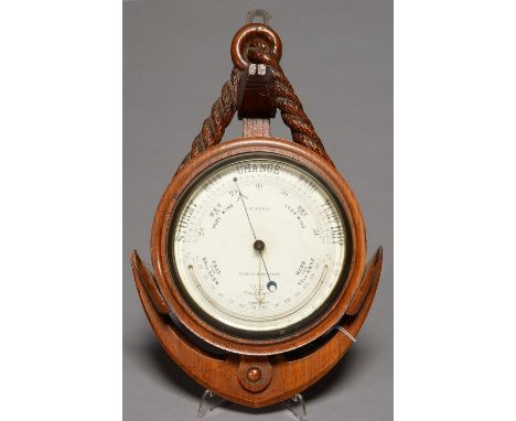 MARITIME INTEREST. A VICTORIAN CARVED OAK ANEROID BAROMETER IN THE FORM OF AN ANCHOR, C1890-1900, THE WHITE EARTHENWARE REGIS