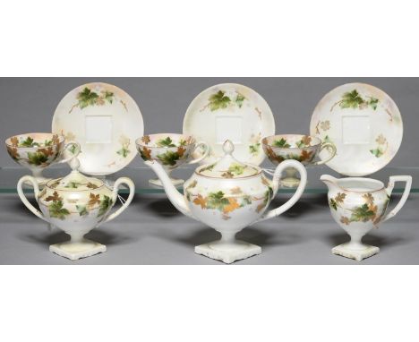 A CONTINENTAL PORCELAIN VASE SHAPED TEA SERVICE, C1900, PRINTED, PAINTED AND GILT WITH TRAILING LEAVES, TEAPOT AND COVER 14CM