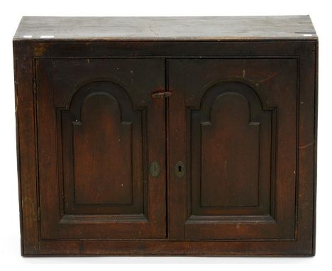 A GEORGE III OAK CUPBOARD, ENCLOSED BY BREAKARCH PANEL DOORS, 68CM H; 87 X 27CM Chips, shrinkage cracks and losses to top, lo