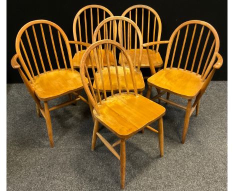 A set of six Ercol Blonde Elm dining chairs, spindle hoop-backs, comprising four chairs and pair of open-arm carver chairs, (