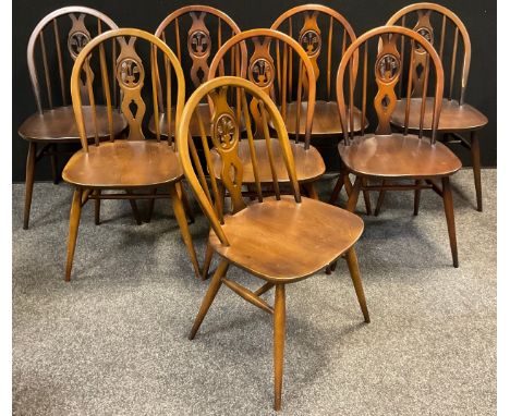 A set of eight Ercol Elm Fleur-de-lys design dining chairs, (8). 