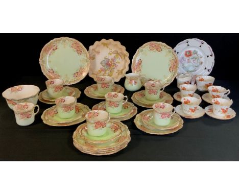 An early 20th century tea set for eight decorated with a underglaze green with a floral print including eight tea cups, seven