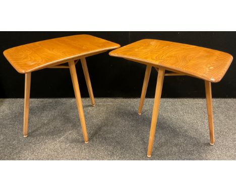 A pair of Ercol, ‘Blonde’ Elm, mid century tripod desk tables (also designed to be used as extension ends to Ercol model 265 
