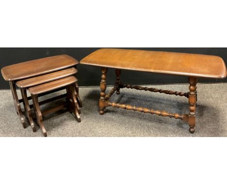 An Ercol nest of three elm tables, the largest 42cm high x 57.5cm x 35cm;  an Ercol elm coffee table, 46.5cm x 105.5cm x 46cm