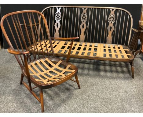 An Ercol three seat sofa, and an Ercol spindle-back single seat armchair, (2). 