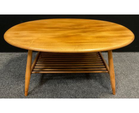 An Ercol, Blonde Elm, oval coffee table, mid century design, turned legs, spindle under-tier, 44.5cm high x 99.5cm long x 83c