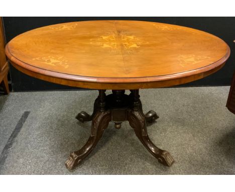 A Victorian inlaid walnut Loo table, oval top, with tilting mechanism to pedestal base, carved cabriole legs, ceramic casters