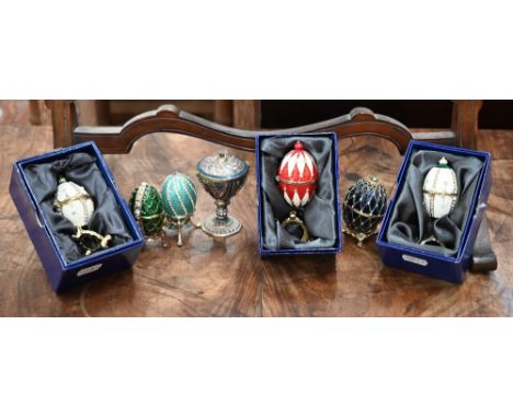 Six Atlas Editions Fabergé eggs (three boxed) to/w an urn and an egg pendant (8) 