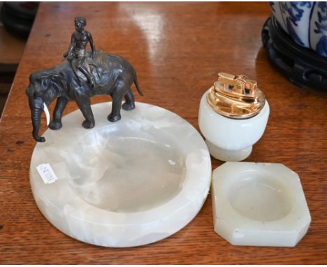 An onyx cufflink bowl surmounted by a bronzed Indian elephant to/w an onyx lighter and ashtray (3) 