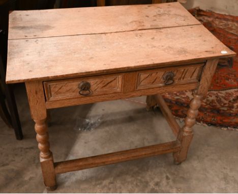 A limed oak side table with frieze drawer on bobbin-turned supports united by stretcher, 86 cm wide x 55 cm x 72 cm high 