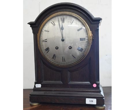 A French oak bracket clock with silvered dial, striking on a coiled gong, 44 cm high 
