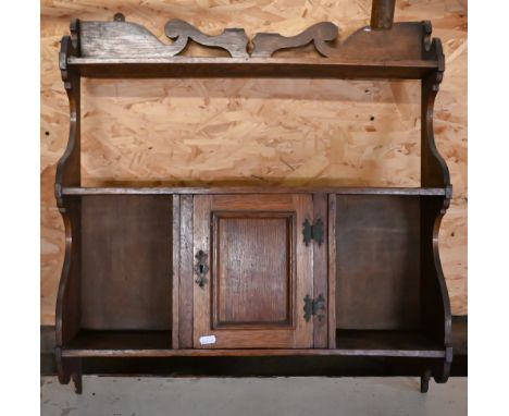 An Arts &amp; Crafts oak wall shelf with central cupboard, 61 x 60 cm high 