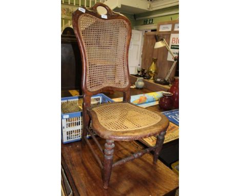 AN OAK FRAMED CONTINENTAL SINGLE CHAIR with bergere back and seat 