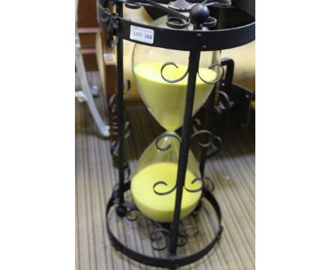 AN OVERSIZED SAND TIMER housed in a wrought metal frame, approx. 4 hour 