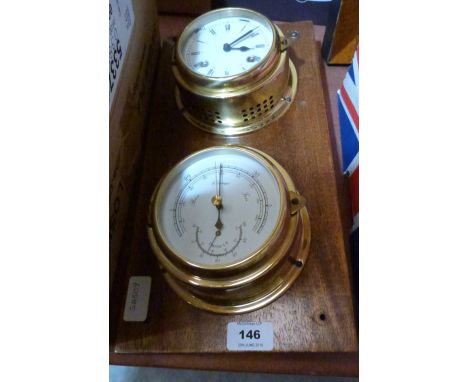 A marine style brass barometer and clock on mahogany wall mount