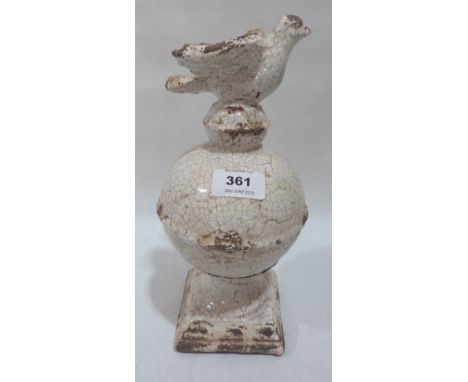 An earthenware crackle glazed finial, surmounted by a bird. 11' high