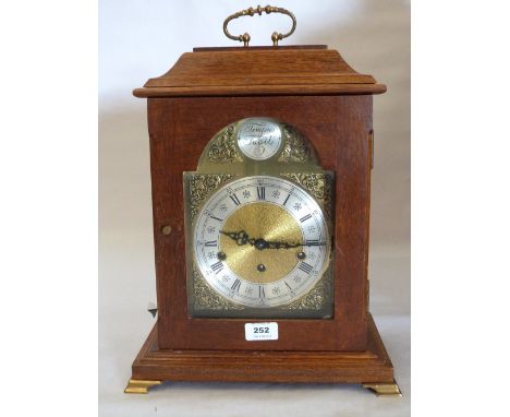 A walnut bracket clock of recent manufacture, the three train German movement striking and chiming on eight gongs. 16' high.
