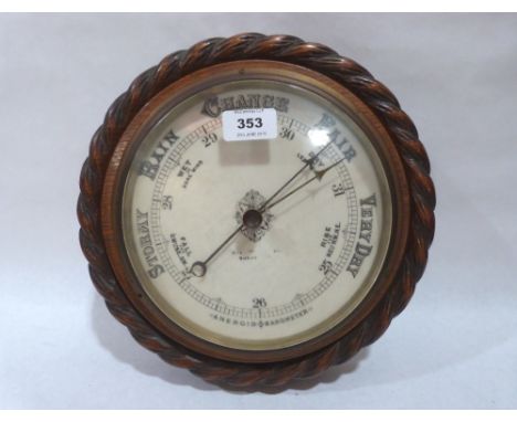 A late Victorian oak aneroid barometer. 11' diam