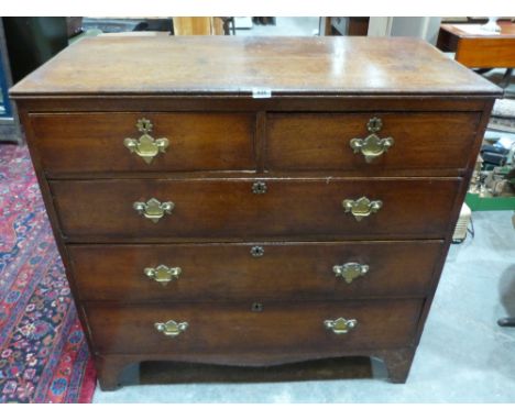 A George III oak chest with two short over three long drawers on bracket feet. 41' wide