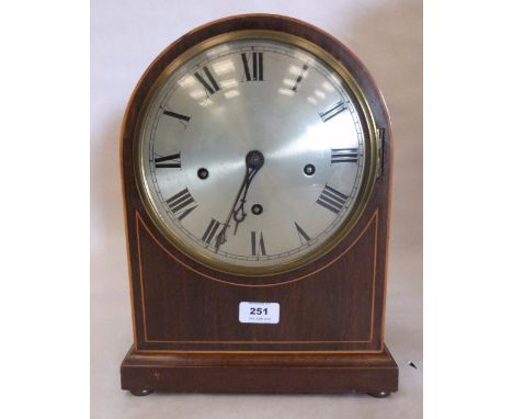 An English mahogany and line inlaid bracket clock with silvered dial, the three train brass movement striking and chiming on 