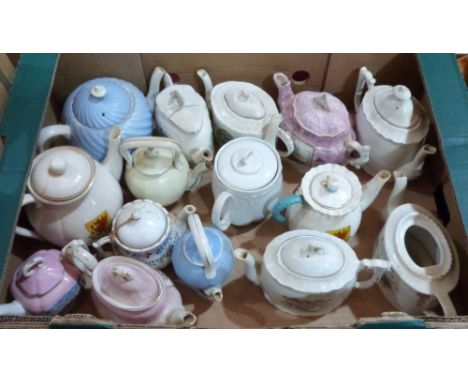 Fifteen crested or souvenir teapots, including Goss