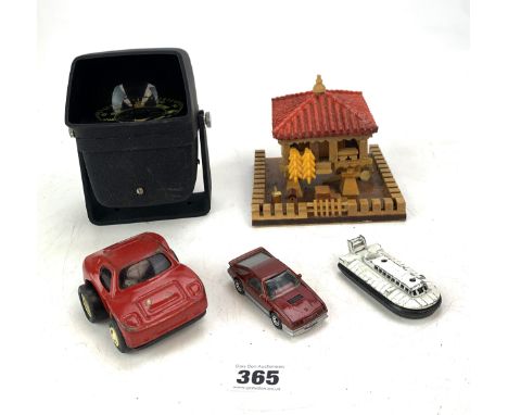 Compass on stand, Tonka car, Matchbox car, Matchbox hovercraft and wooden house with lift up lid