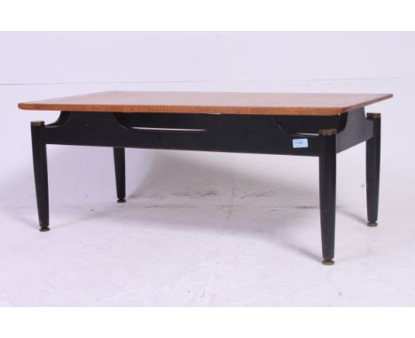 A vintage Ernest Gomme G Plan coffee table with black ebonised frame having brass detailing
H39 x W99 x D48 cm 