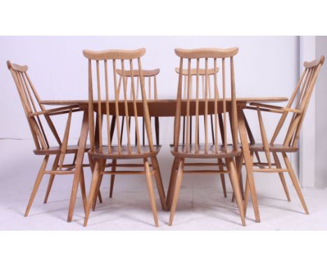 An Ercol elm and beech Windsor dining table, raised on square, tapered legs along with a set of six Ercol Goldsmith chairs tw