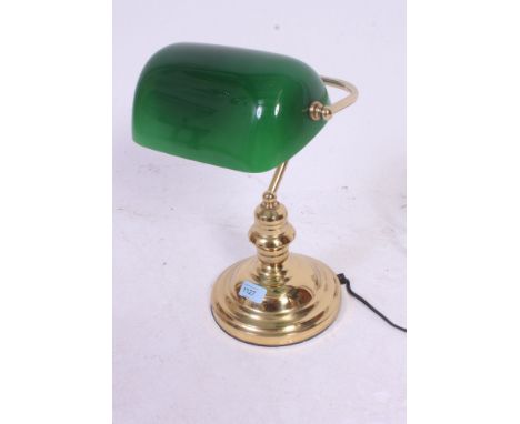 A 20th century contemporary brass base bankers / desk lamp having green shade on shaped column