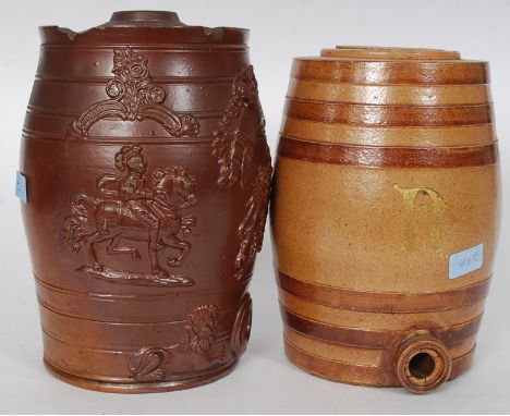 A 19th stoneware spirit barrel being marked R for Rum in gilt together with a stoneware heavily embossed example with lions a