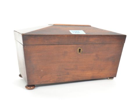 A 19th century mahogany sarcophagus shaped tea caddy with hinged top having sectioned caddy interior.