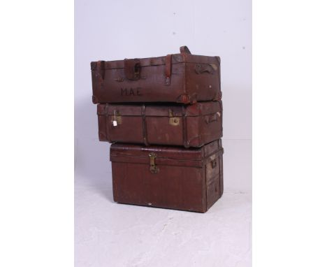 2 vintage canvas and wooden / leather strapped steamer trunks, both with hinged centres, one with inner tray. Together with a